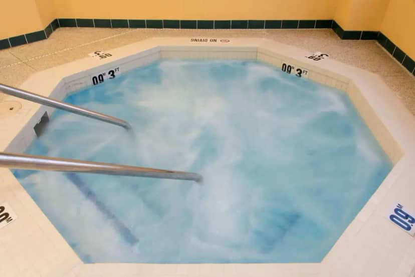 a jacuzzi tub with clouds in the water at Hampton Inn Grand Rapids-South in Wyoming