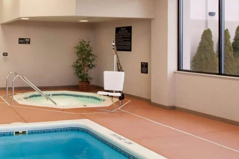 a spa room with a jacuzzi tub in a building at Hampton Inn Muskegon in Muskegon Heights