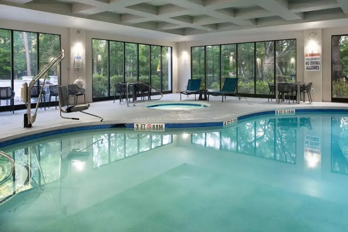 a large swimming pool in a hotel with windows at Hampton Inn Northwood in Myrtle Beach