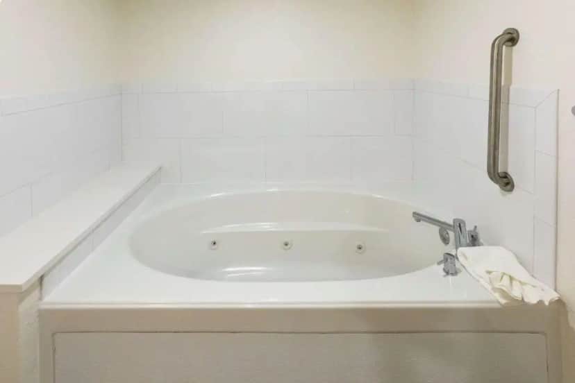 a white bath tub in a white bathroom at Hampton Inn Saint Augustine Beach in Saint Augustine Beach