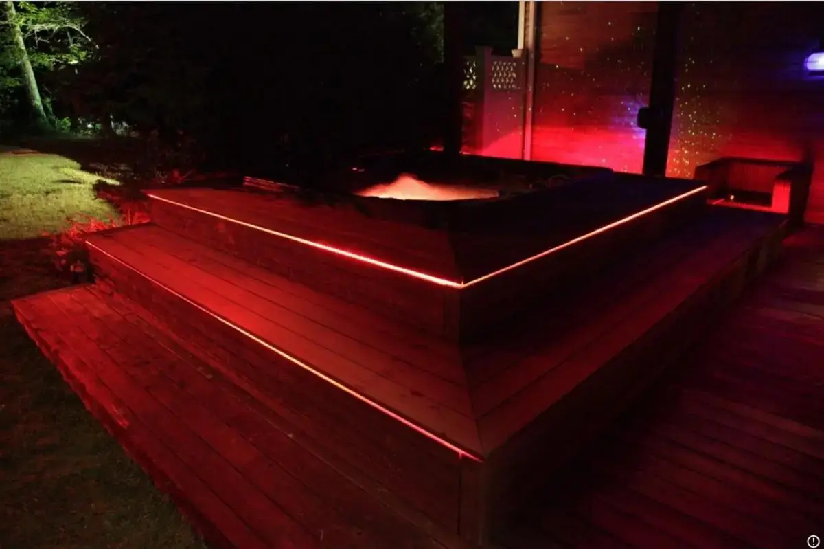 a hot tub with red lights on a deck at Hamptons 9BD MEGA Compound w POOL TENNIS BBALL NIGHTCLUB in Sag Harbor