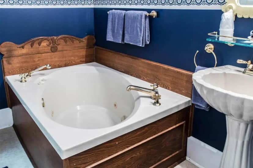 a bathroom with a bath tub and a sink at Hidden Springs Bed and Breakfast in Eureka Springs