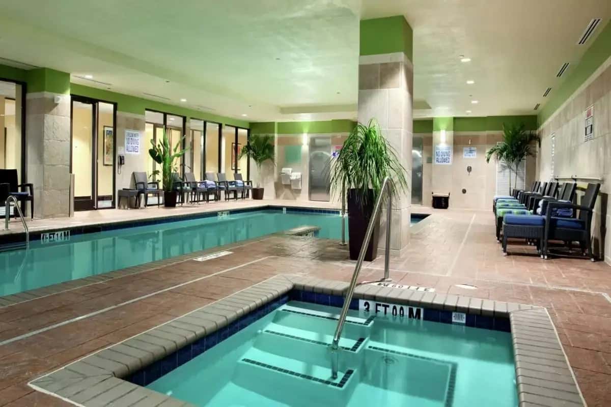 a pool in a hotel lobby with a swimming pool at Hilton Asheville Biltmore Park in Asheville