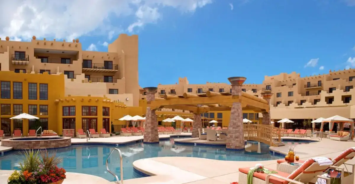 a resort with a swimming pool and buildings at Hilton Santa Fe Buffalo Thunder in Pojoaque