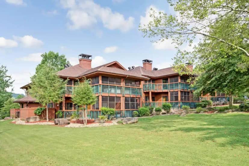 an exterior view of a large house with a yard at Hilton Vacation Club Bent Creek Golf Village Gatlinburg in Pittman Center