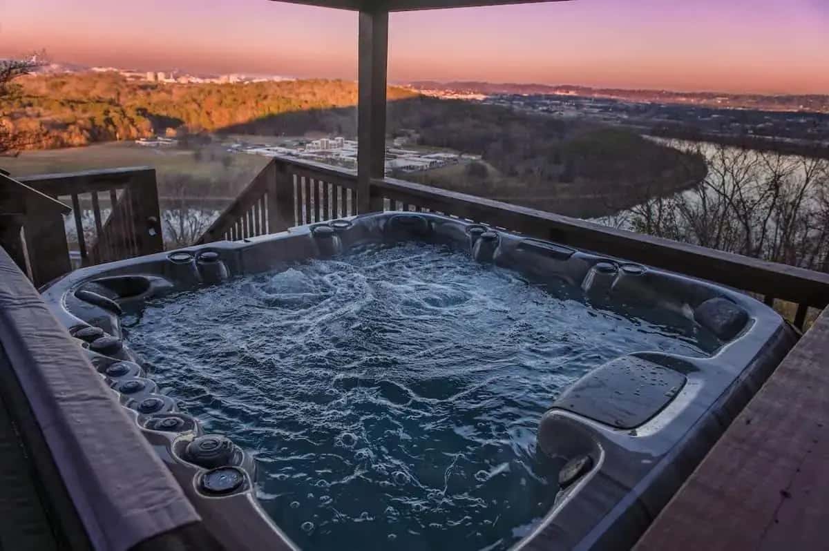 a jacuzzi tub on a deck with a view at Historic Riverview Inn Five in Chattanooga