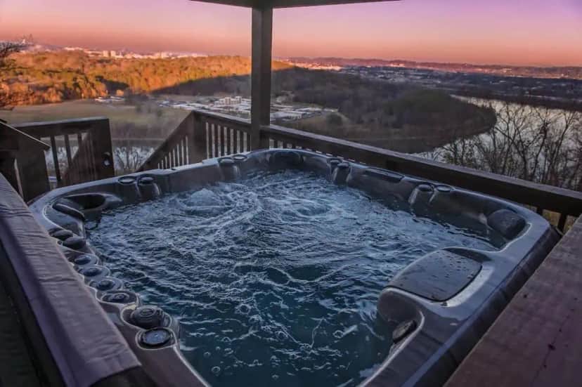 a jacuzzi tub on a deck with a view at Historic Riverview Inn Five in Chattanooga