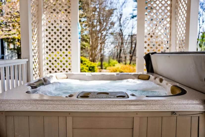 a jacuzzi tub on top of a porch at Hiwassee Room on Lookout Mountain in Lookout Mountain