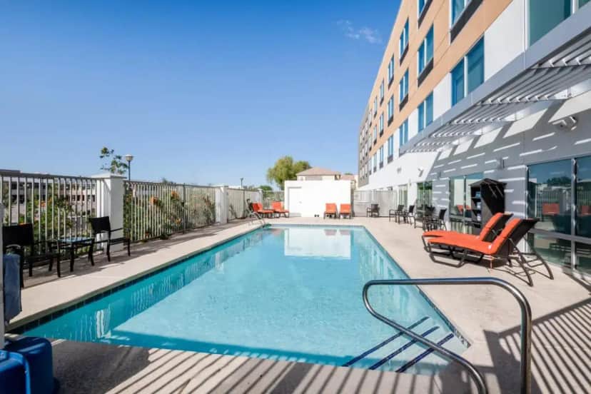 a swimming pool on the side of a building at Holiday Inn Express & Suites - Phoenix - Airport North by IHG in Phoenix