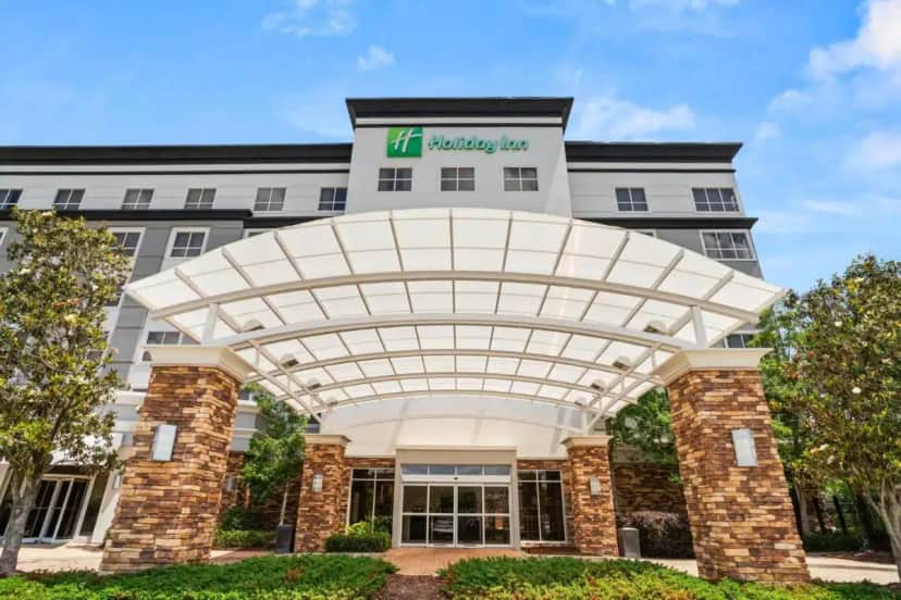 a rendering of a building with awning in front at Holiday Inn Baton Rouge College Drive I-10 by IHG in Baton Rouge