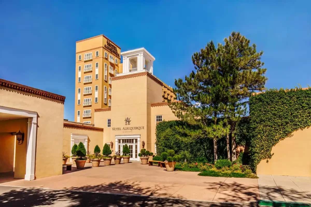 a building with a tree in front of a building at Hotel Albuquerque At Old Town in Albuquerque