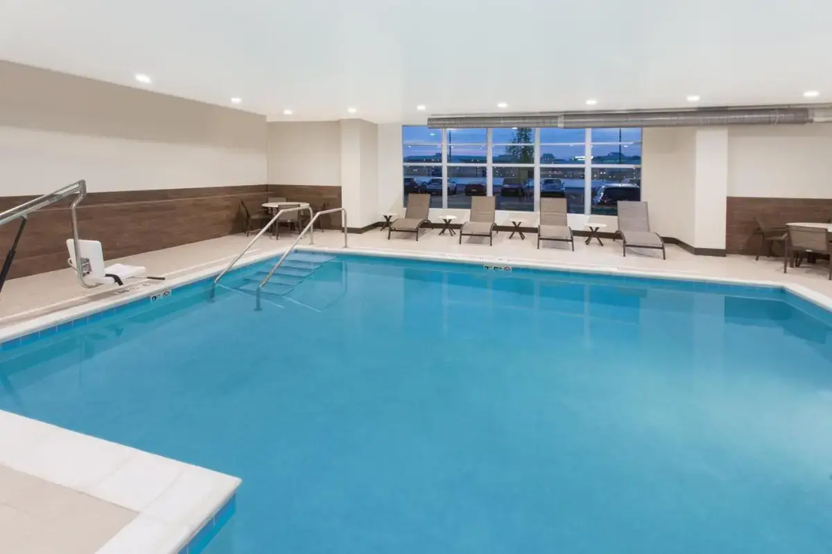 a large swimming pool in a hotel room at Holiday Inn Express & Suites Sandusky by IHG in Sandusky