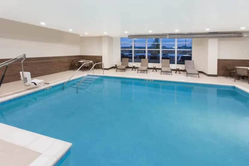 a large swimming pool in a hotel room at Holiday Inn Express & Suites Sandusky by IHG in Sandusky