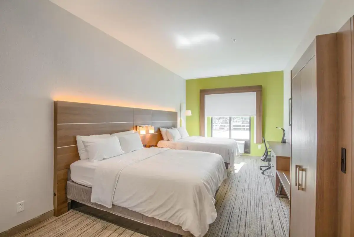 a hotel room with two beds and a window at Holiday Inn Express Hotel & Suites Gulf Shores by IHG in Gulf Shores