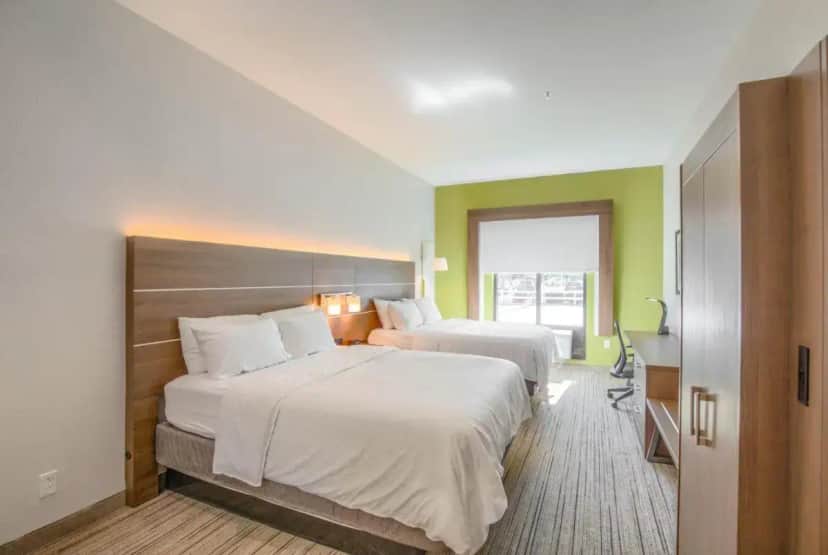a hotel room with two beds and a window at Holiday Inn Express Hotel & Suites Gulf Shores by IHG in Gulf Shores