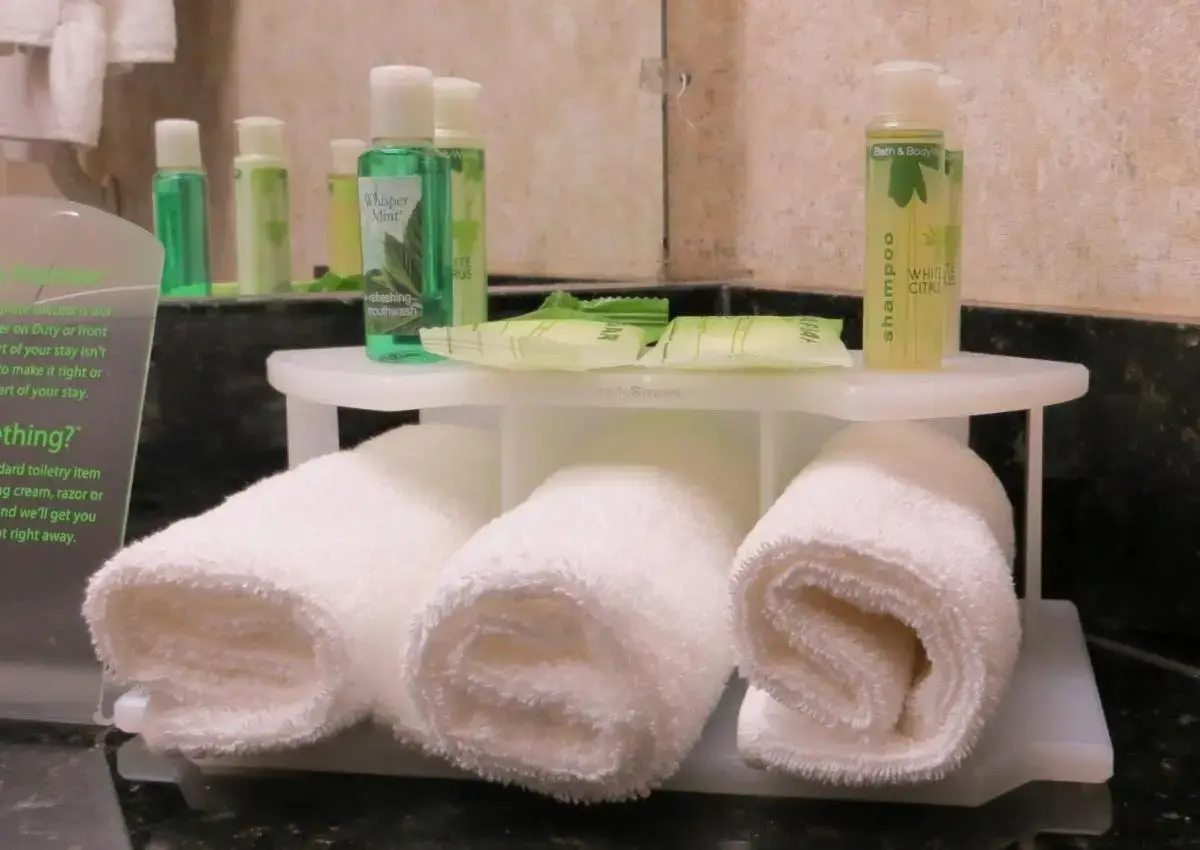 a white shelf with towels on it in a bathroom at Holiday Inn Express Hotel & Suites Nogales by IHG in Nogales