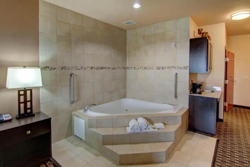 a large bathroom with a tub and a sink at Holiday Inn Express Hotel & Suites Paris by IHG in Paris