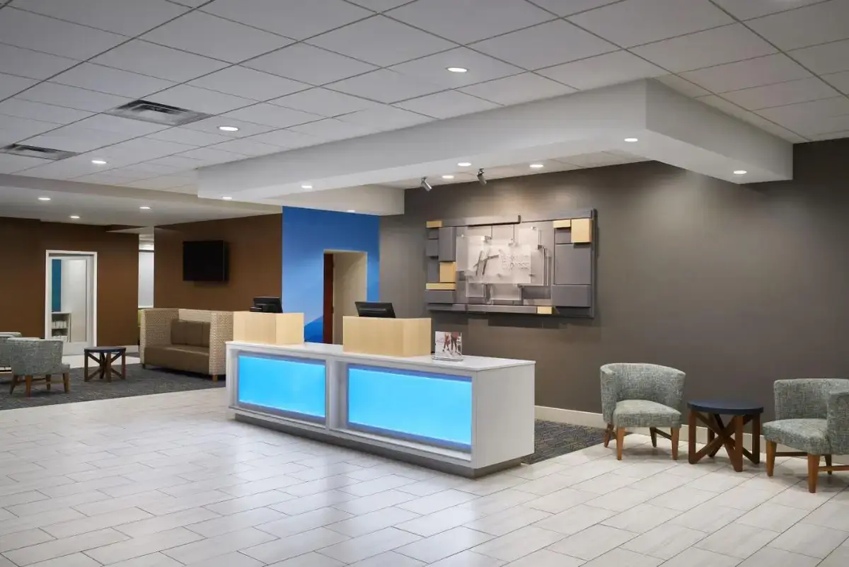 a lobby with a waiting room with chairs and a counter at Holiday Inn Express - Richmond Downtown by IHG in Richmond