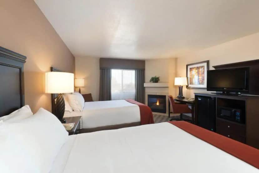 a hotel room with two beds and a flat screen tv at Holiday Inn Express Show Low by IHG in Show Low