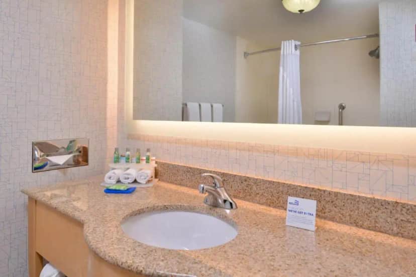 a bathroom with a sink and a mirror at Holiday Inn Express Stockton Southeast by IHG in Stockton