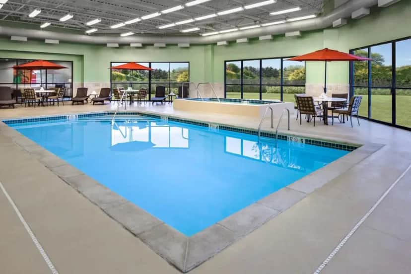 a large pool with blue water in a building at Holiday Inn Wichita East I-35 by IHG in Wichita