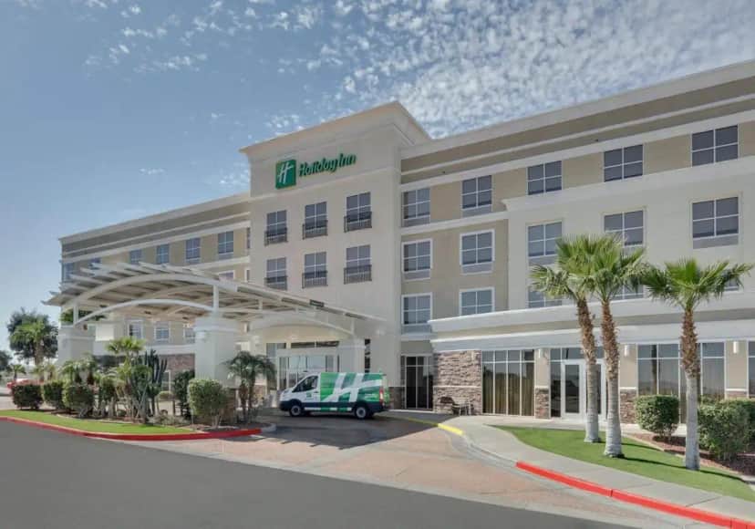 a hotel with a van parked in front of it at Holiday Inn Yuma by IHG in Yuma