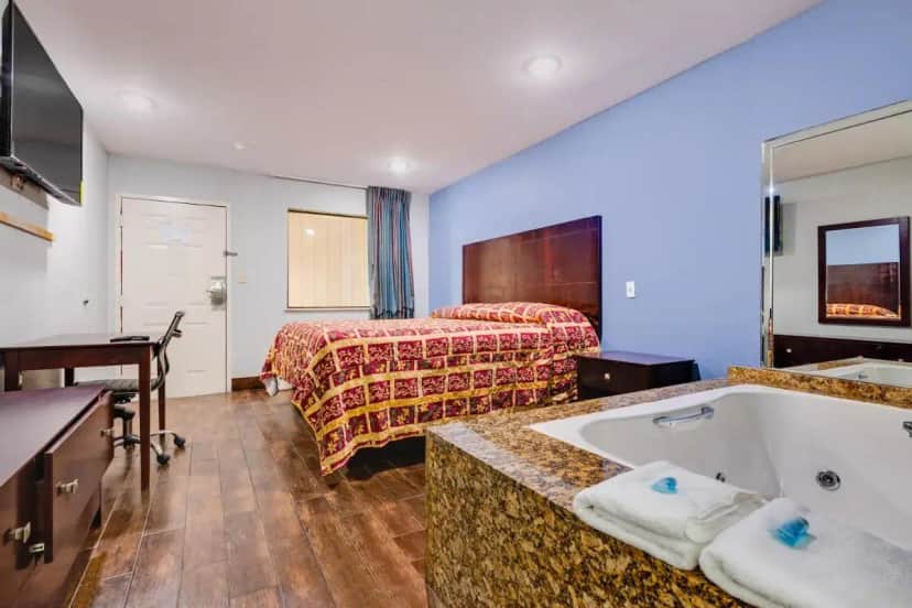 a hotel room with two beds and a bath tub at Hotel O Luxury Inn Channelview Baytown I-10 in Channelview