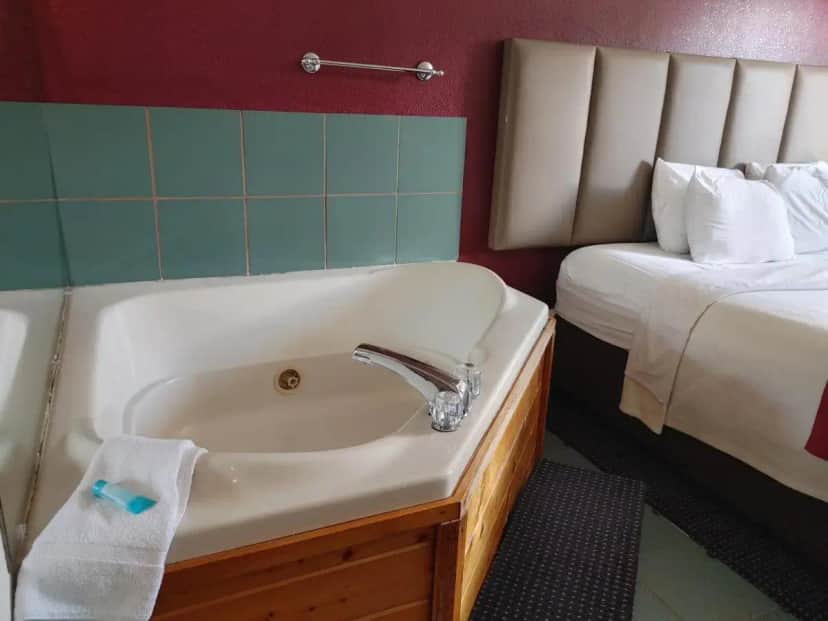 a bathroom with a sink and a bed at Hotel Pigeon Forge in Pigeon Forge