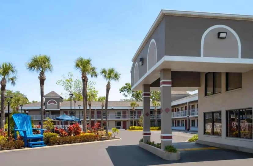 a view of the front of a hotel with palm trees at Hotel South Tampa & Suites in Tampa