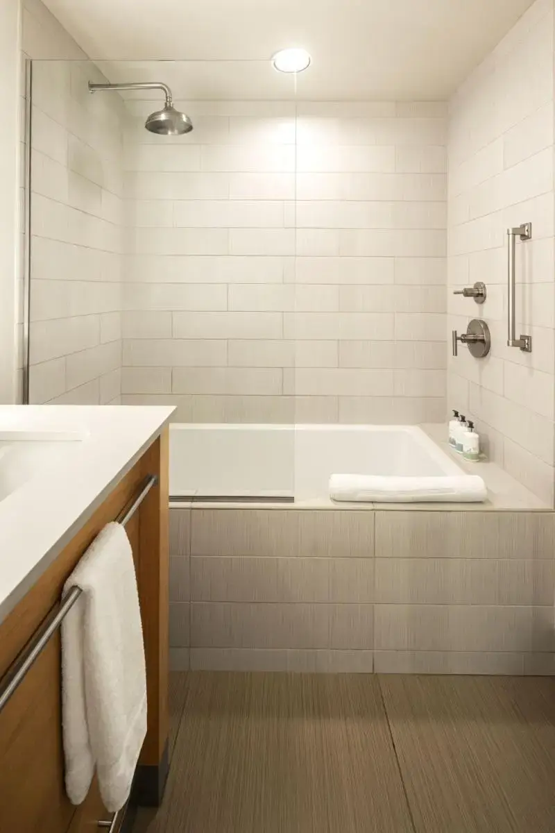 a white bathroom with a tub and a sink at Hotel Terra Jackson Hole, a Noble House Resort in Teton Village