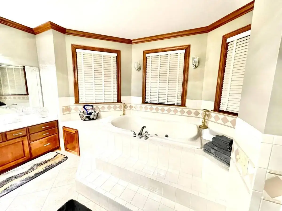 a large bathroom with a tub and a sink at Huge Farmstay w/ Pool, Animals, Pond, & Game Room in La Plata