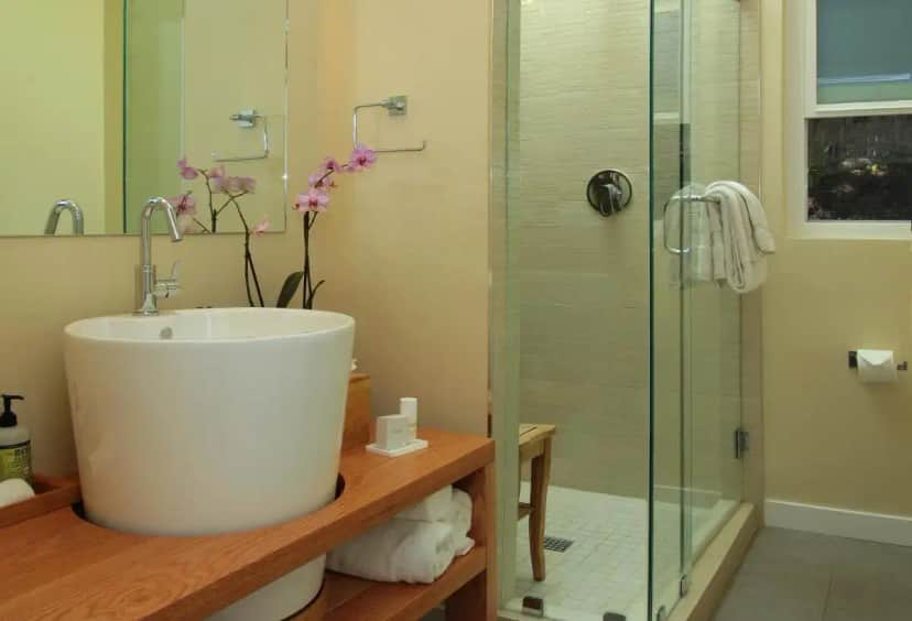 a bathroom with a sink and a glass shower at Inn at Moonlight Beach in Encinitas
