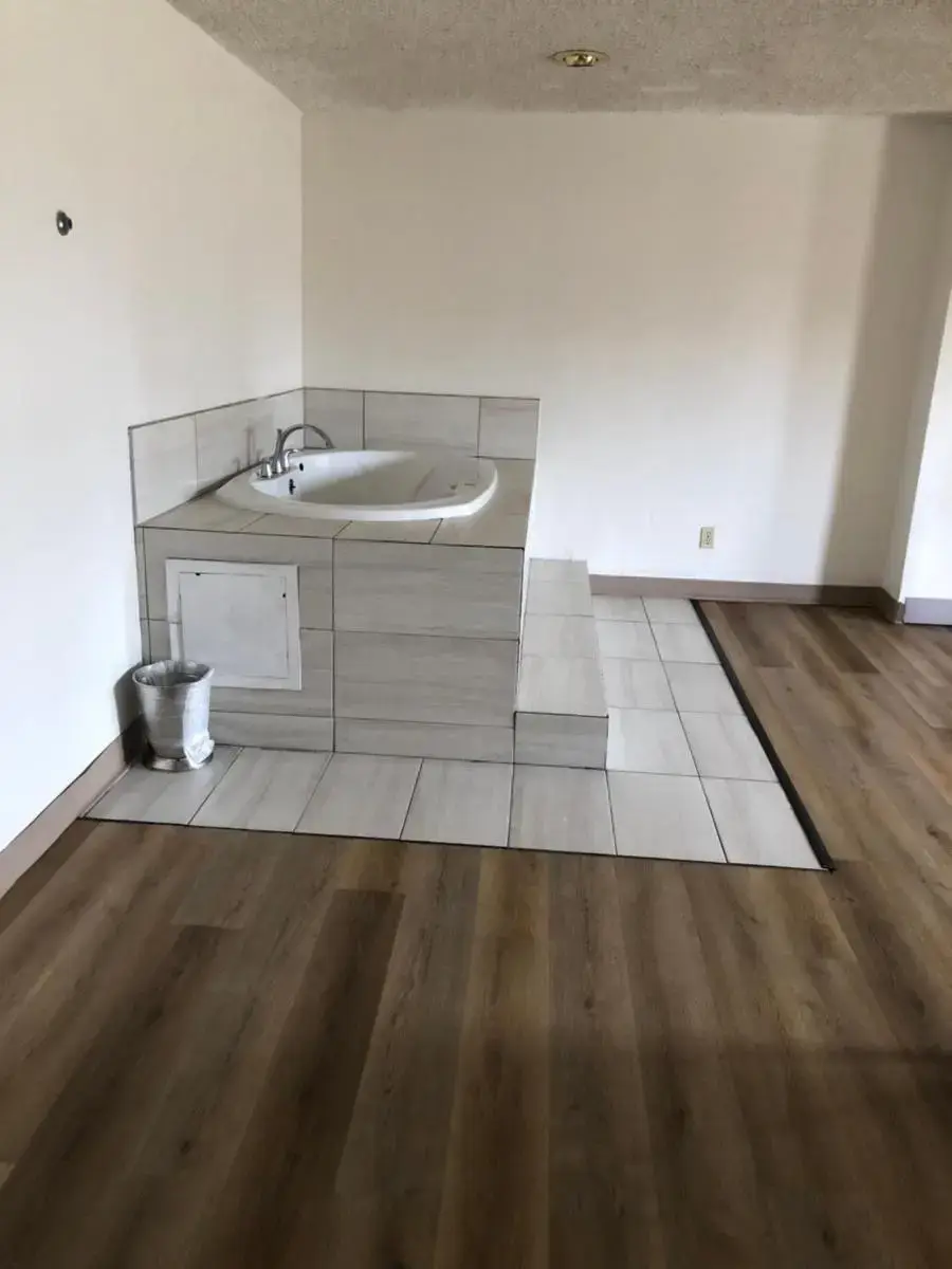 a bathroom with a sink and a wooden floor at Inn at the Highland Denver Downtown in Denver