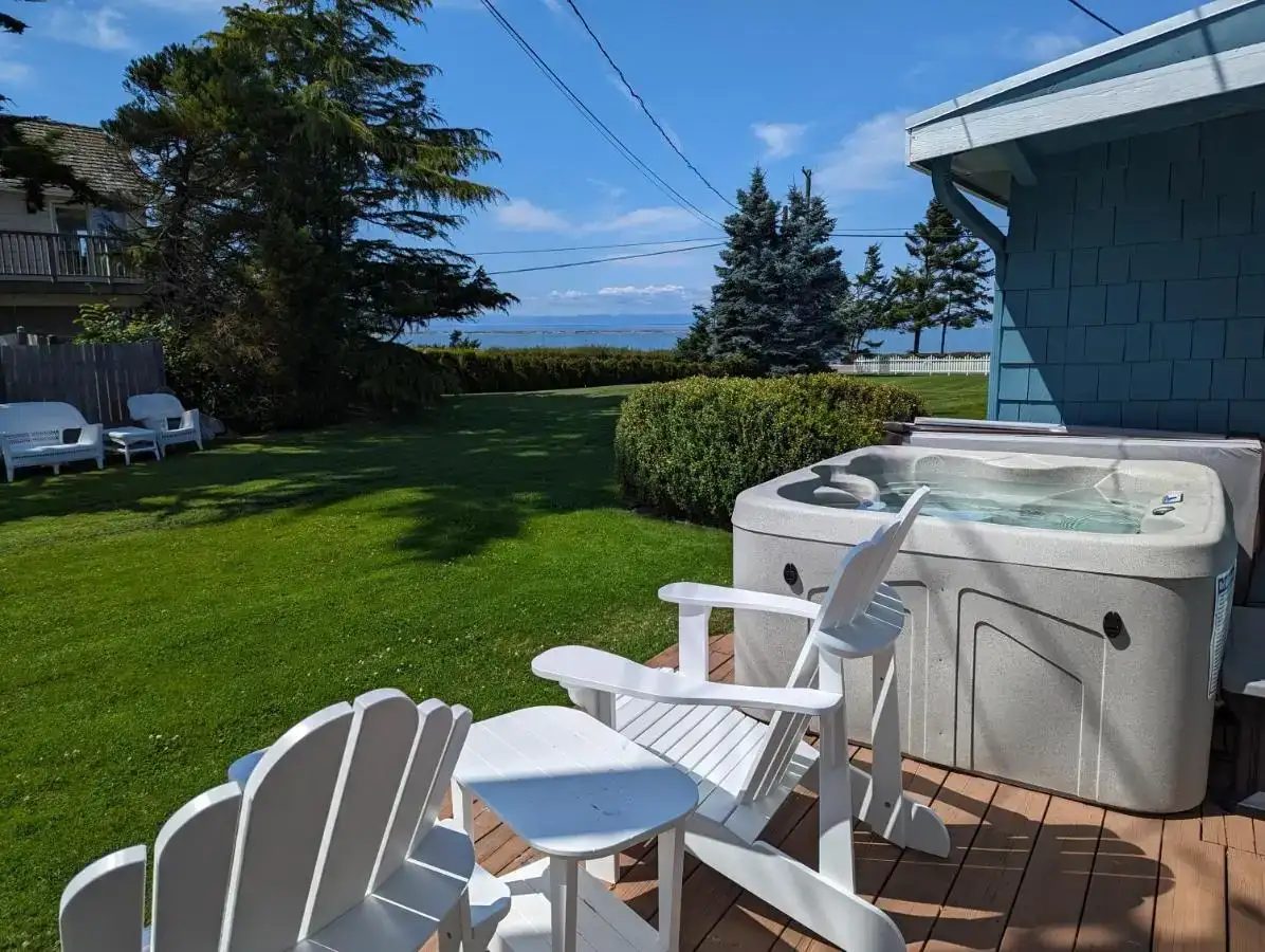 two chairs and a hot tub in a yard at Juan de Fuca Waterfront Hotel & Cottages in Sequim