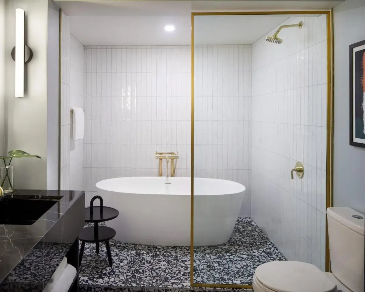 a bathroom with a tub and a toilet at Kimpton Alton Fisherman's Wharf by IHG in San Francisco