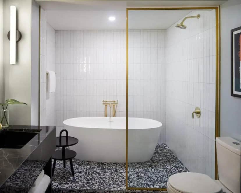 a bathroom with a tub and a toilet at Kimpton Alton Fisherman's Wharf by IHG in San Francisco