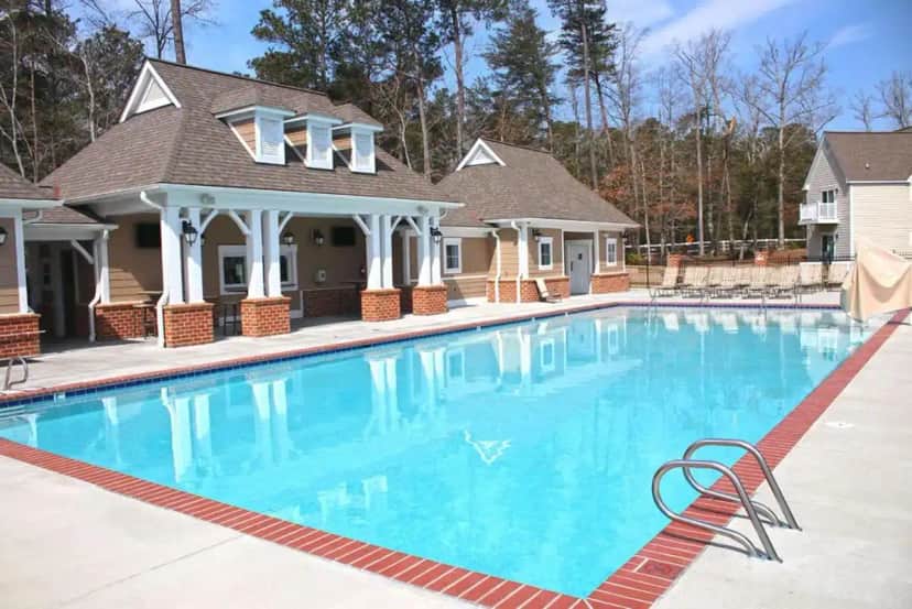 a large blue swimming pool in a house at Kings Creek Plantation by Tripforth in Williamsburg
