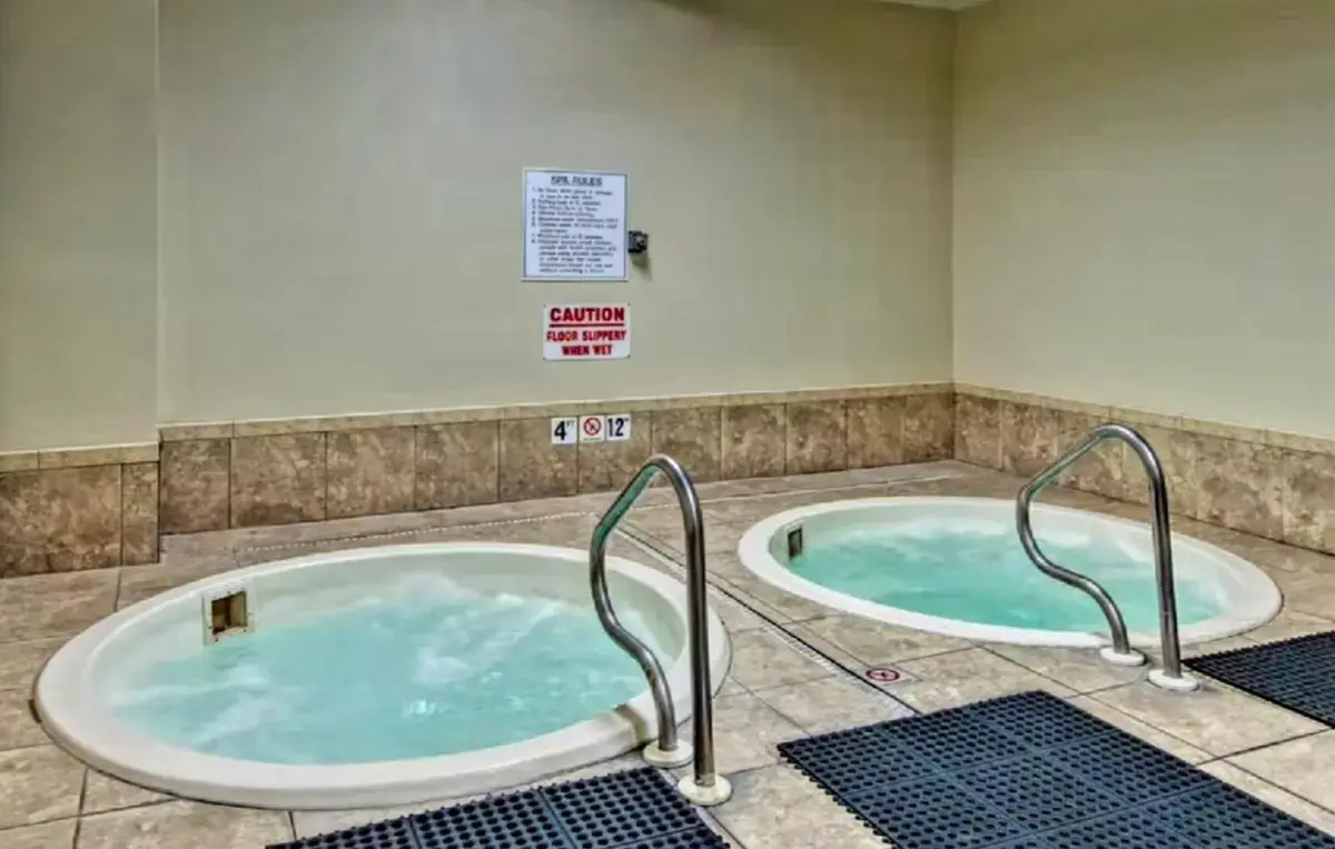 a jacuzzi tub with two handles in a bathroom