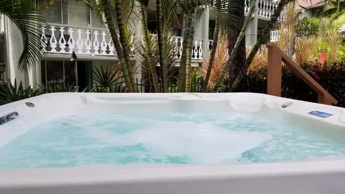 a jacuzzi tub with water in front of a building at Kona Islander Inn - Prime Downtown Location with Hot Tub, Pool & Beach in Kailua-Kona