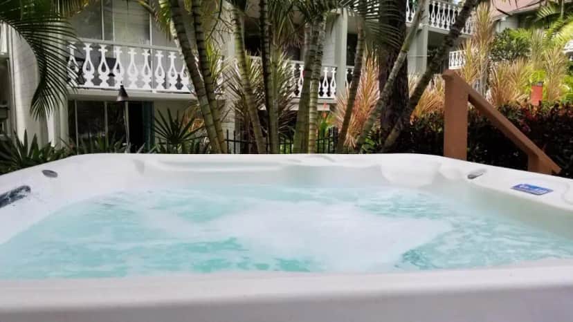 a jacuzzi tub with water in front of a building at Kona Islander Inn - Prime Downtown Location with Hot Tub, Pool & Beach in Kailua-Kona