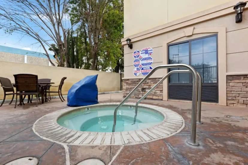 a hot tub with a hand rail in a patio at La Quinta by Wyndham NE Long Beach/Cypress in Hawaiian Gardens