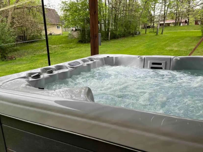 a hot tub with water in it in a yard at Lake Lovers Hideaway Near Lake Geneva in Elkhorn