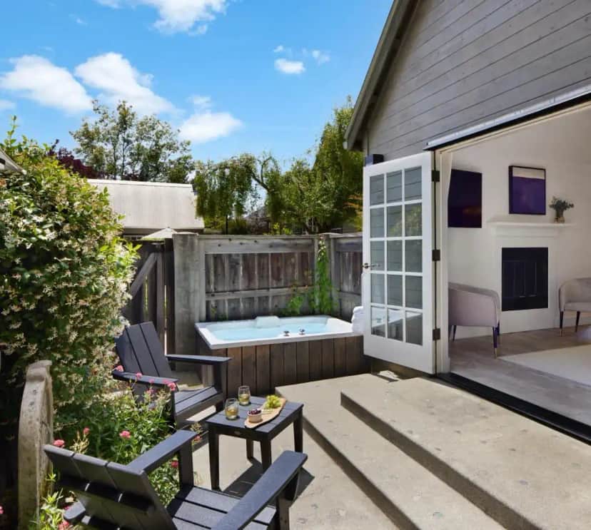 a backyard with a hot tub and patio furniture at Lavender, A Four Sisters Inn in Yountville