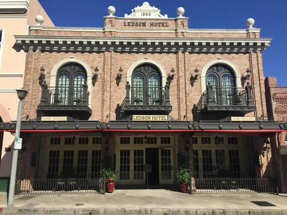 a large brick building with two balconies on the front at Ledson Hotel & Zina Lounge in Sonoma