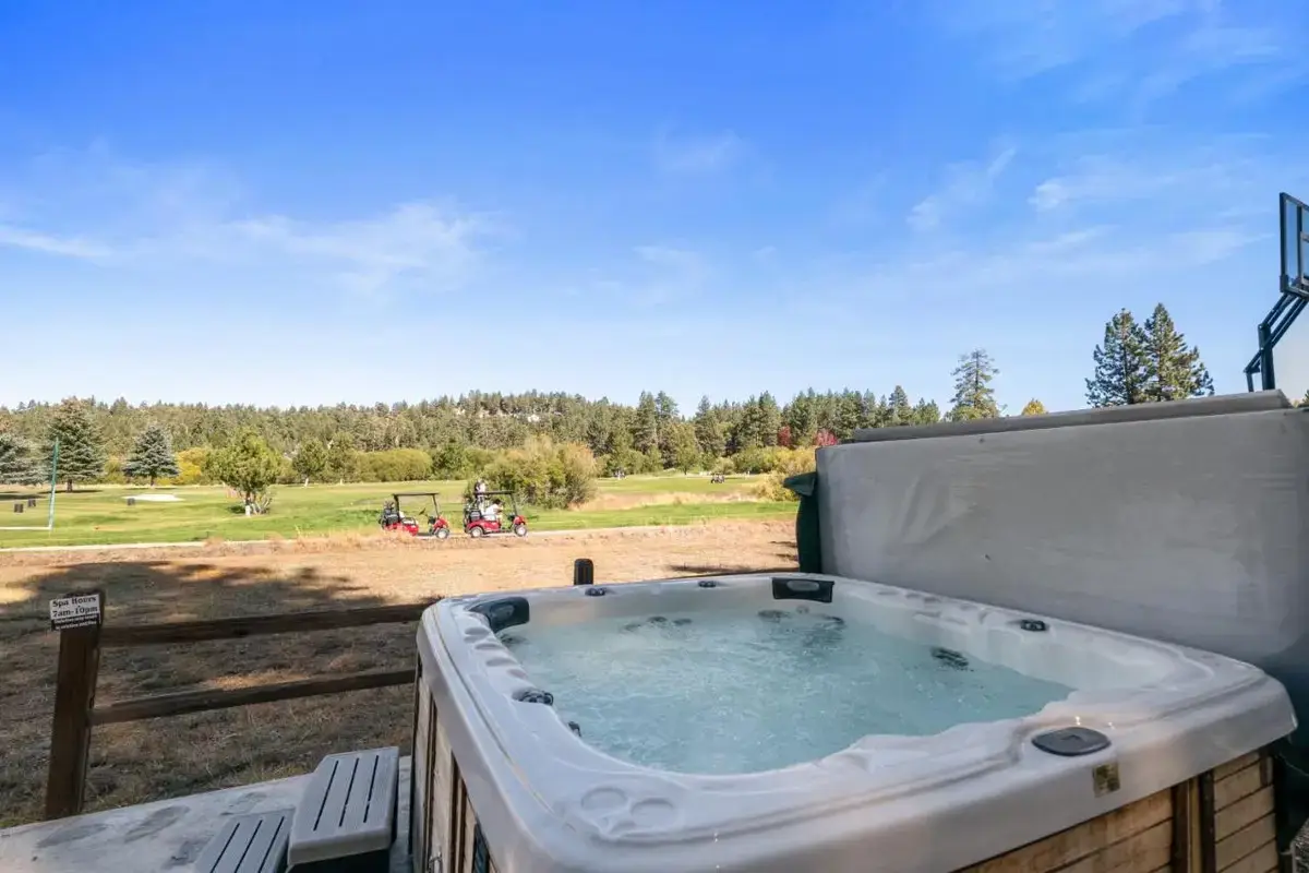 a jacuzzi tub sitting on top of a fence at Little Pine Chalet - Walk to Slopes, Hot Tub, Ping Pong in Big Bear Lake