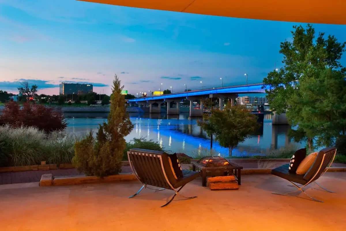 two chairs and a table with a view of a river at Little Rock Marriott in Little Rock