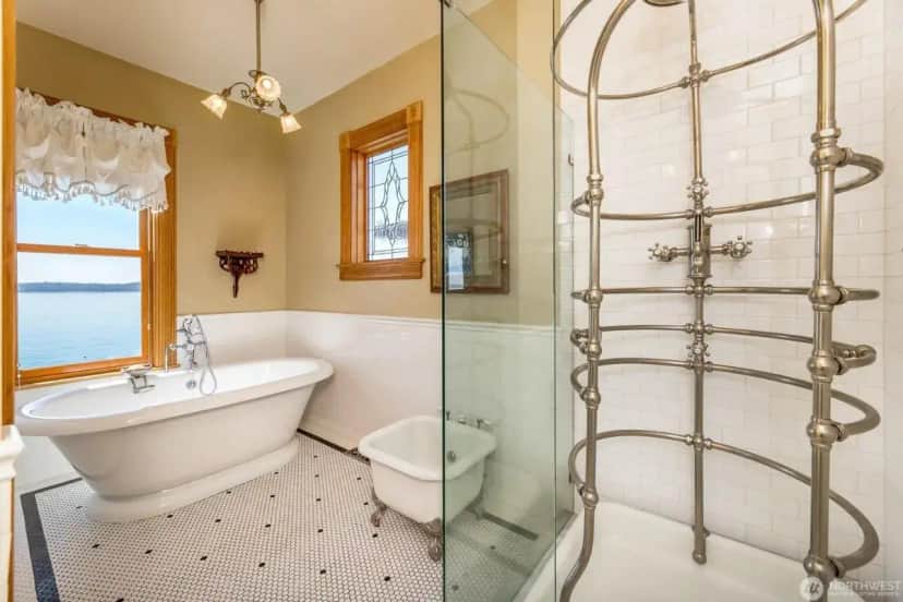 a bathroom with a tub and a toilet and a shower