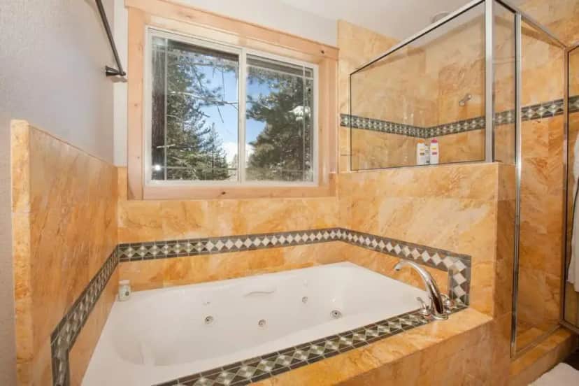 a bath tub in a bathroom with a window at Luxury Home Near Lake, Heavenly, Casinos in South Lake Tahoe