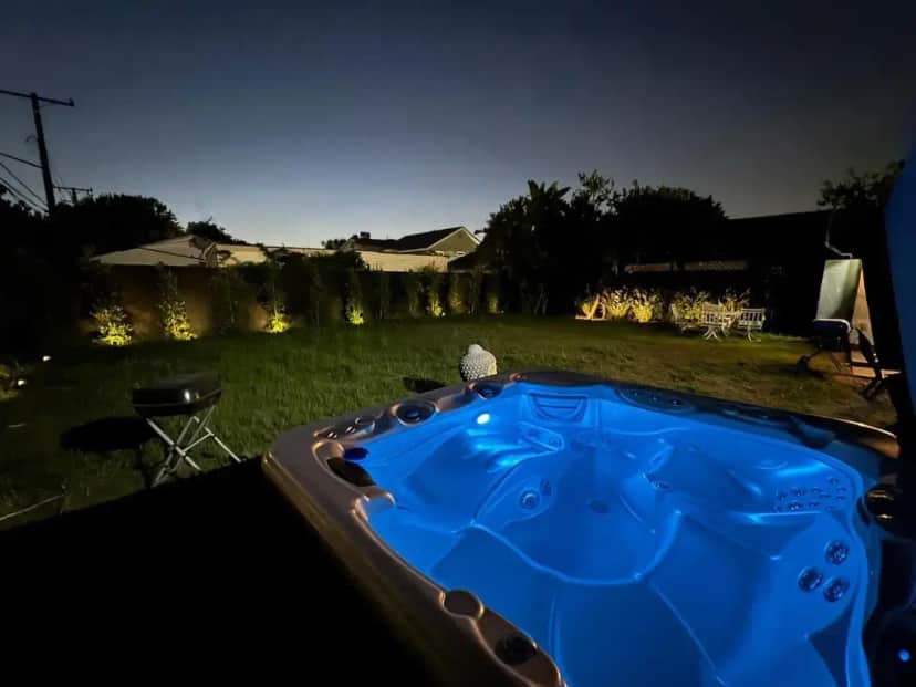 a blue hot tub in a yard at night at LUXURY VILLA Estate Oasis in Downey