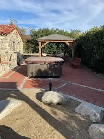 a hot tub and a gazebo on a patio at Miracle Springs Resort and Spa in Desert Hot Springs